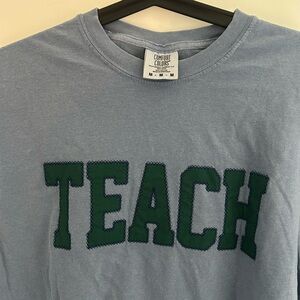 Comfort Colors Light Blue T-Shirt with Green 'Teach' Graphic